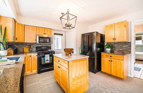Petoskey House | Charming home with large backyard, firepit, grill, patio, and private W/D