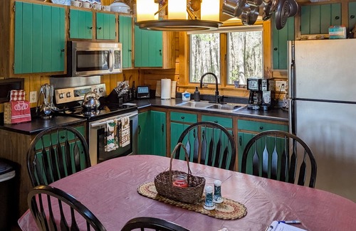 Wiscasset House | Charming riverfront home with cozy interiors, dock, and scenic deck views