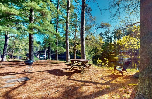Manitowish Waters Cabin | Charming waterfront cottage with shared firepit, canoe, paddlebaot & docks