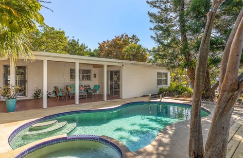River Isles House | Coconut cove - peaceful garden retreat with HEATED pool on canal near the beach!