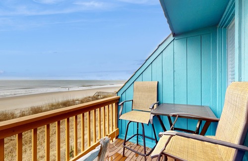 Ocean Isle Beach Condo | Colorful ocean view condo with pool, central AC, & private washer/dryer