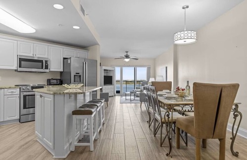 Morehead City Condo | Come watch the Dolphin play! Pool, Jacuzzi, & Gym Walking distance to the Beach!
