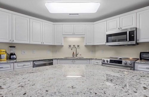 Morehead City Condo | Come watch the Dolphin play! Pool, Jacuzzi, & Gym Walking distance to the Beach!