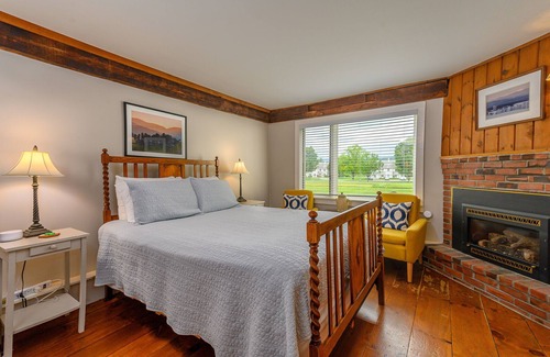 Stowe Bed & Breakfast | Comfortable, pet friendly room with queen bed, a stunning view of Mount Mansfield, sitting area and a fireplace with full service breakfast included