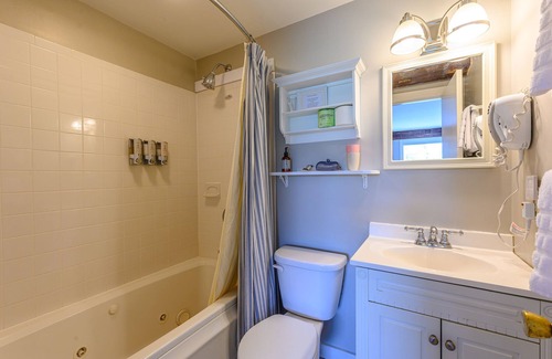 Stowe Bed & Breakfast | Comfortable, pet friendly room with queen bed, a stunning view of Mount Mansfield, sitting area and a fireplace with full service breakfast included