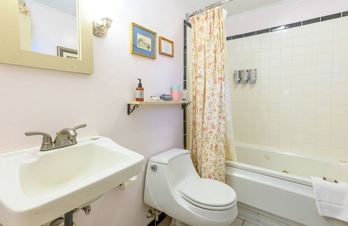 Stowe Bed & Breakfast | Comfortable room with queen bed and twin trundle, a stunning view of Mount Mansfield, sitting area with couch and a parlor stove with full service breakfast included