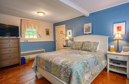 Stowe Bed & Breakfast | Comfortable room with queen bed, a stunning view of Mount Mansfield, sitting area and a parlor stove with full service breakfast included