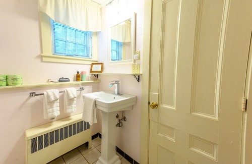 Stowe Bed & Breakfast | Comfortable room with queen bed, a stunning view of Mount Mansfield, sitting area and a parlor stove with full service breakfast included