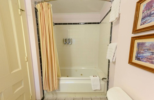 Stowe Bed & Breakfast | Comfortable room with queen bed, a stunning view of Mount Mansfield, sitting area and a parlor stove with full service breakfast included