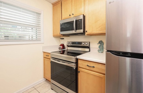 West Panama City Beach House | Convenience - Dedicated covered parking at entrance to unit, steps from beach
