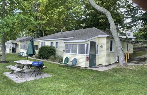 Ludington Cottage | Cottage 3 is a charming 2 bedroom 25’ from your boat dock & Hamlin lake.