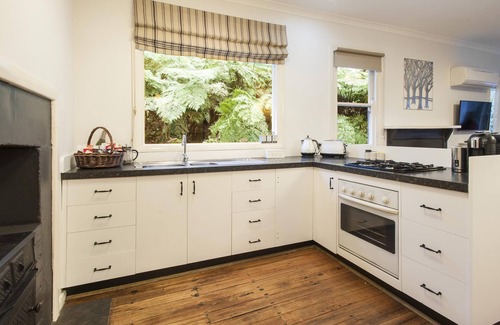 Olinda Cottage | Cottage In The Forest - Relax in your King size bed looking out onto the forest, curl up on the lounge with open wood fire.