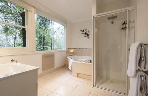 Olinda Cottage | Cottage In The Forest - Relax in your King size bed looking out onto the forest, curl up on the lounge with open wood fire.