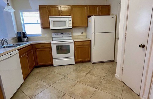 Lady Lake House | Courtyard Villa with gas golf cart located between two Town Squares!