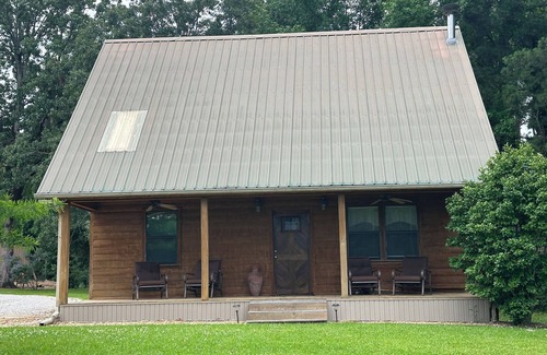 Longleaf Cabin | Cozy Cabin setting behind a 1 1/2 acre pond that is lined with Cypress Trees.