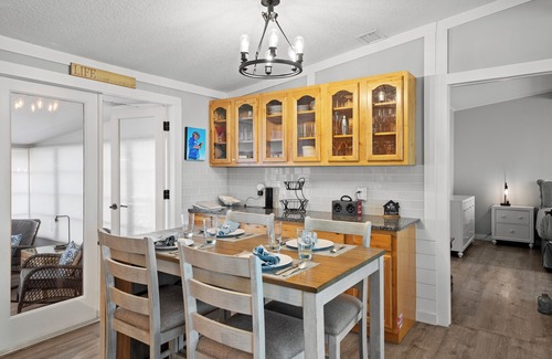 Butler Beach House | Cozy Canal Escape! Screen Covered Pool, Sunroom, Sun Deck, & Floating Boat Dock