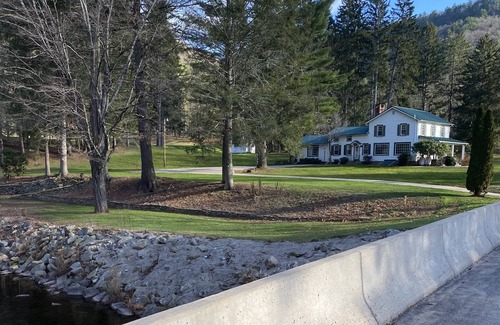 Hillsgrove House | Creek side house with fireplace and concrete driveway.