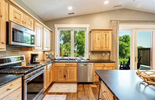 Sheridan Condo | Creekside 2BR/2BA retreat in the Powderhorn Golf Community. Steps from clubhouse, pool, and tennis courts with a private patio overlooking Goose Creek.