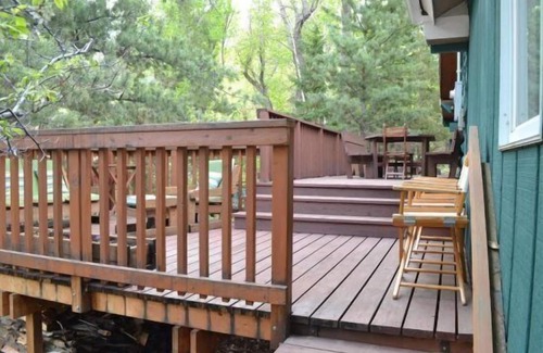 Wapiti Cabin | Creekworks Cabin- Wapiti Valley, surrounded by trees with creek access