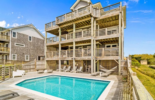 Salvo House | Dazzling waterfront home with balconies, private pool, hot tub, & game room