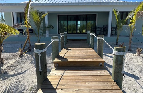 Treasure Cay House | Deep water Canal front home w/dock across the street from the beach.