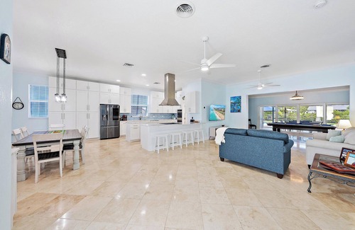 Palm City House | Deep water front home with private dock, pool, outdoor kitchen and pool table.