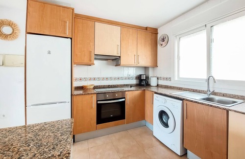 Vinaros Apartment | Delight your family with this beachfront vacation rental with shared outdoor pool.