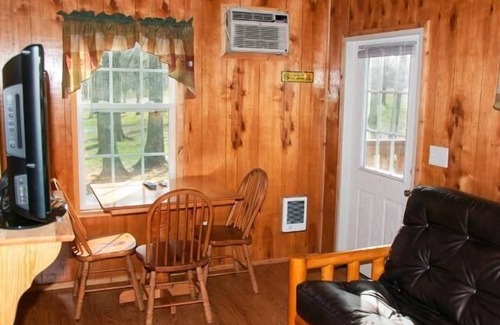Manchester Cabin | Deluxe Cabin (w/Bathroom) - Deluxe Cabin (w/Bathroom) Better than a motel! Enjoy camping in comfort! Kitchen with stove top and full size fridge with dishes pots included. Full bathroom with shower. Cable TV DVD player. Gas grill on your own concre