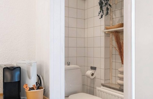 Zoutelande Apartment | Discover the charm of a stylish small seaside room with Ibiza vibes, featuring a private bathroom.