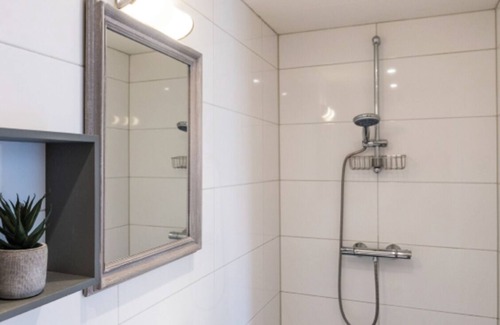 Zoutelande Apartment | Discover the charm of a stylish small seaside room with Ibiza vibes, featuring a private bathroom.