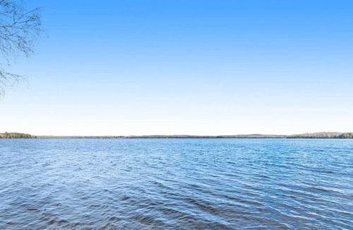 Presque Isle Cabin | Dog-friendly cabin with lakefront views, swimming, fishing, firepit, & rec room