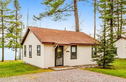 Presque Isle Cabin | Dog-friendly lakefront cabin with swimming, fishing, boating, & rec room