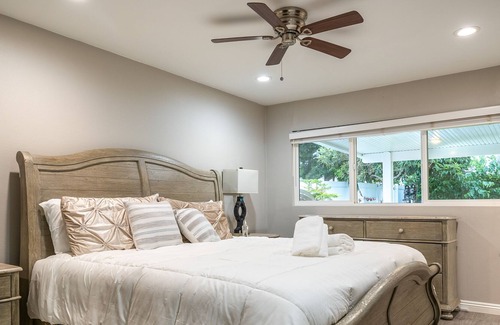 Orange House | Dog-friendly retreat near Disney with enclosed yard, cornhole, central AC, & W/D