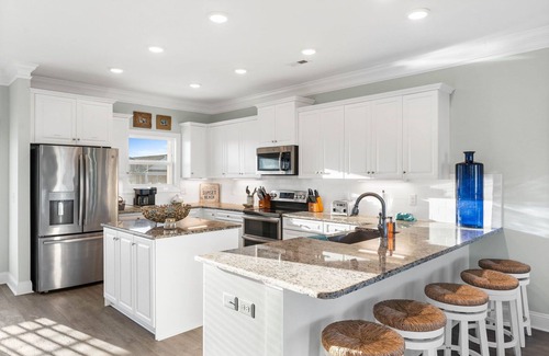 Sunset Beach House | Easy Breezy is a stunning 4 bedroom, 4 bathroom house with a private pool and elevator