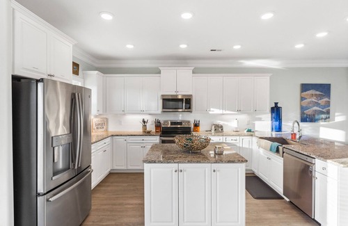 Sunset Beach House | Easy Breezy is a stunning 4 bedroom, 4 bathroom house with a private pool and elevator