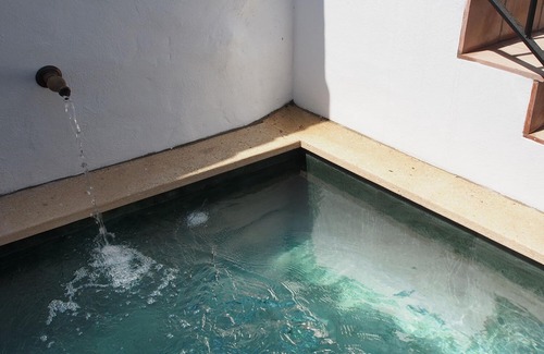 Riogordo House | El Patio de Lola, an Andalusian village house with green marble splash pool.