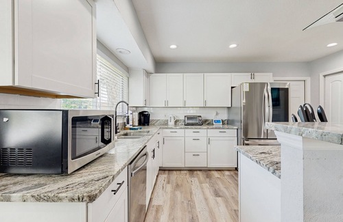 Palm Harbor House | Elegant sound view home with enclosed pool, dock, pool table, fireplace, & grill