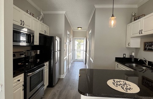 Central Myrtle Beach Condo | Endless Summer Updated Condo at Magnolia Place - Pool & Golf Course Views!