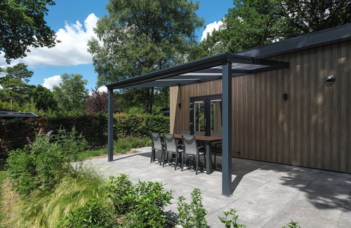 Lieren House | Enjoy a luxurious holiday home for 4 people in the wooded nature of the Veluwe, complete with modern amenities, air conditioning, a stylish pergola, and a cozy lounge area with an outdoor fireplace for ultimate comfort and ambiance, both day and nigh