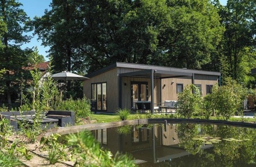 Lieren House | Enjoy a luxurious holiday home for 4 people in the wooded nature of the Veluwe, complete with modern amenities, air conditioning, and a stylish pergola for ultimate comfort. You can also completely unwind in the wonderful private hot tub and sauna, p