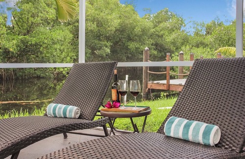 Fort Myers House | Enjoy a stunning waterfront view, pool table,kayaks, fishing, BBQ, heated & pool