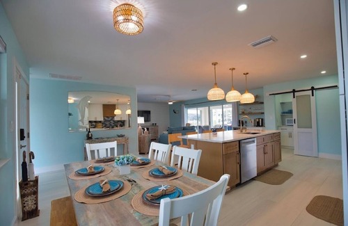 Punta Gorda House | Enjoy a tranquil vacation on expansive canal with passing boats and heated pool.