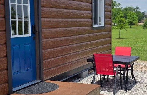 Tuscumbia Cabin | Enjoy cabin #64 at Heritage Acres Park with swimming, splash pad & more!