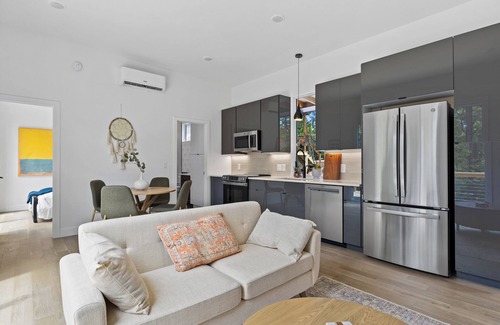 Young Harris Apartment | Escape to a 2BR/1BA tiny home in the North Georgia mountains. Create meals in the chef’s kitchen, cozy up by the wood-burning stove, refresh in the spa-style shower, and enjoy crisp mountain air and brilliant fall colors from your private deck.