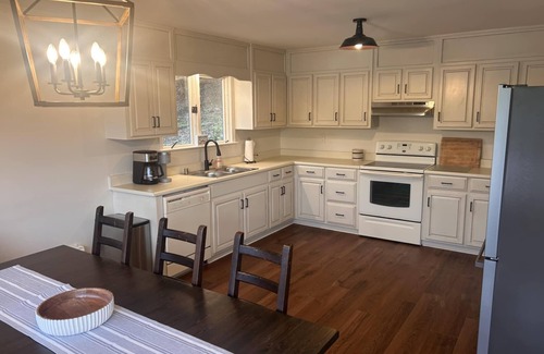 Grant House | Escape to our beautifully updated lakeside retreat, where every detail is designed for comfort and relaxation. From the moment you step inside this 3 bed/2bath house, you'll be captivated by sweeping, unobstructed views of the lake through expansive