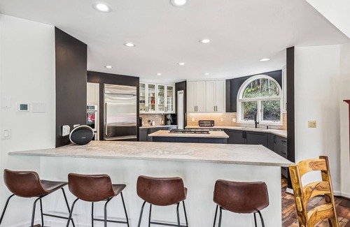 Dunkin Hill House | Experience luxury at Stormbunker Paradise, a spacious 4-bedroom house with stunning wooded views!