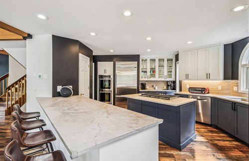 Dunkin Hill House | Experience luxury at Stormbunker Paradise, a spacious 4-bedroom house with stunning wooded views!
