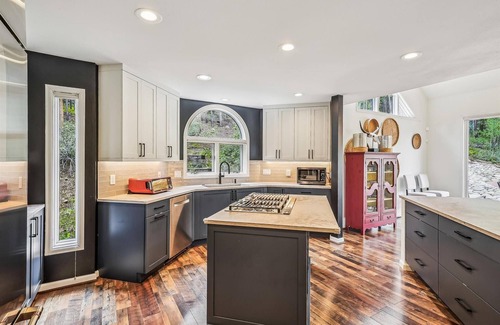 Dunkin Hill House | Experience luxury at Stormbunker Paradise, a spacious 4-bedroom house with stunning wooded views!