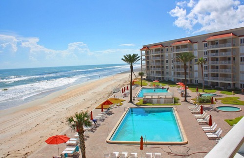 New Smyrna Beach Condo | Fantastic Oceanfront three bedroom. Travertine floors, custom kitchen and bathrooms. Luxury Condo!