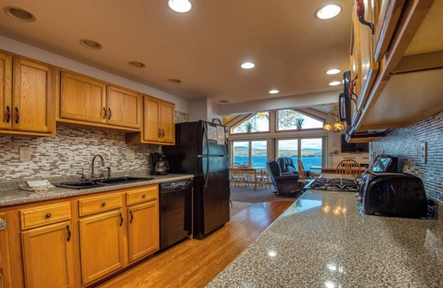 Rangeley House | Fielding Lakehouse - Spacious home with nice grass area leading to Rangeley Lake